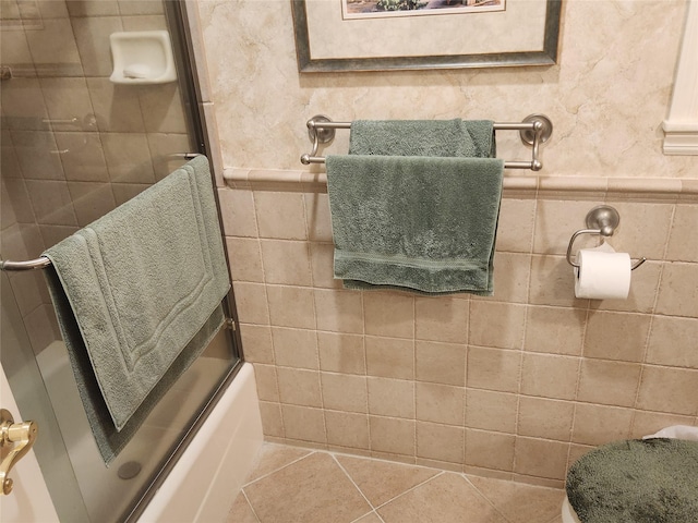 166 Southgate Cir, Massapequa Park, NY 11762 - bathroom with tile patterned floors, bath / shower combo with glass door, and tile walls