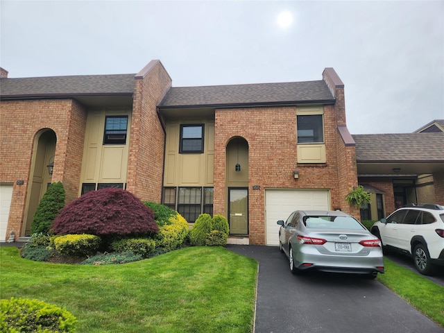 166 Southgate Cir, Massapequa Park, NY 11762 - multi unit property with brick siding, driveway, roof with shingles, an attached garage, and a front yard