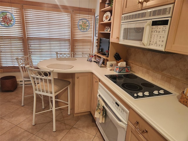 166 Southgate Cir, Massapequa Park, NY 11762 - kitchen featuring white appliances, light tile patterned floors, decorative backsplash, light countertops, and a peninsula