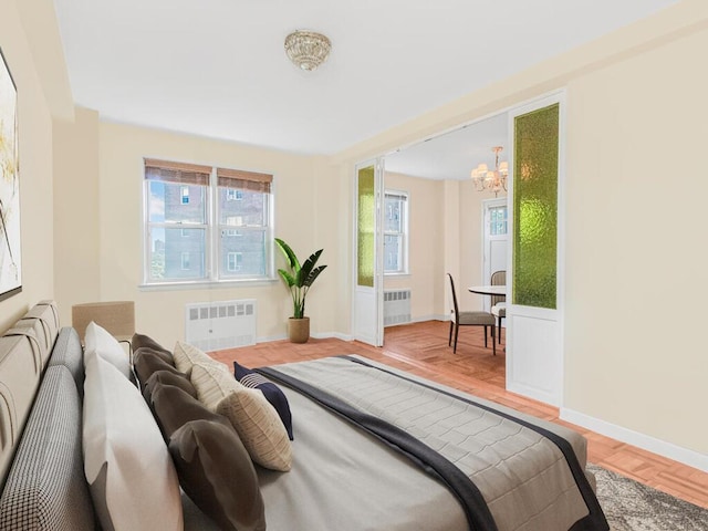 5550 Fieldston Rd Unit 8D, Bronx, NY 10471 - bedroom with radiator, a chandelier, and multiple windows