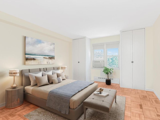 5550 Fieldston Rd Unit 8D, Bronx, NY 10471 - bedroom featuring two closets, cooling unit, baseboards, and radiator heating unit