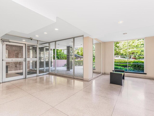 5550 Fieldston Rd Unit 8D, Bronx, NY 10471 - lobby with a wall of windows and recessed lighting