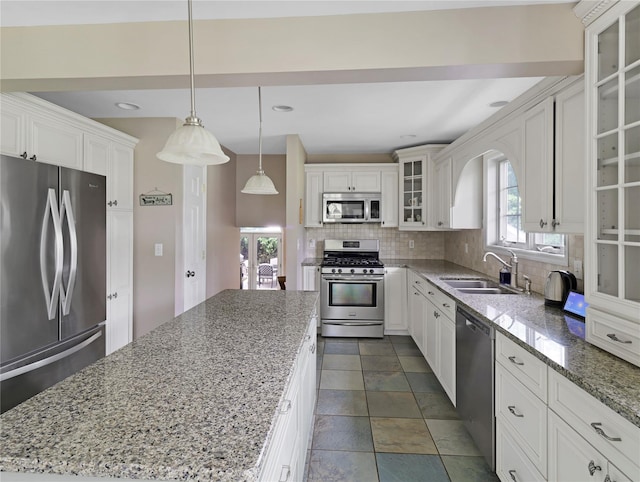 26 Van Nostrand Pl, Nanuet, NY 10954 - kitchen with stainless steel appliances, a sink, decorative backsplash, white cabinets, and recessed lighting