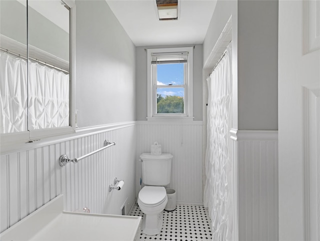 26 Van Nostrand Pl, Nanuet, NY 10954 - full bath with a wainscoted wall, toilet, and a shower with shower curtain