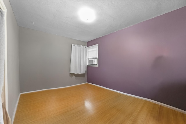 160 Laconia Ave, Staten Island, NY 10305 - unfurnished room with wood finished floors, baseboards, and cooling unit
