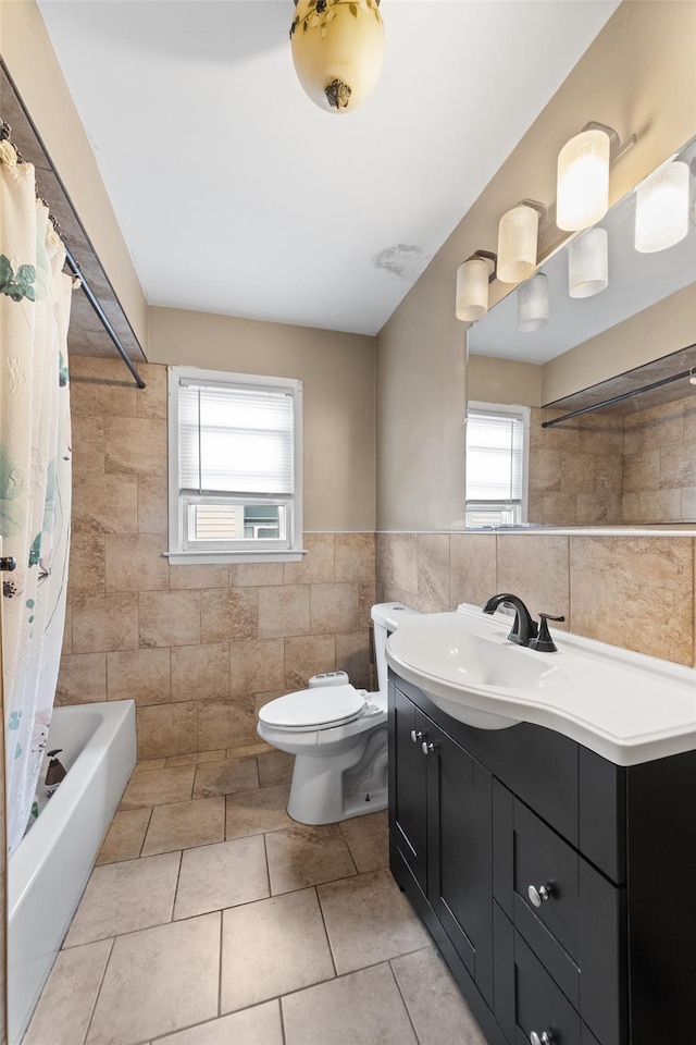 160 Laconia Ave, Staten Island, NY 10305 - bathroom with tile walls, vanity, toilet, tile patterned floors, and shower / bath combo with shower curtain