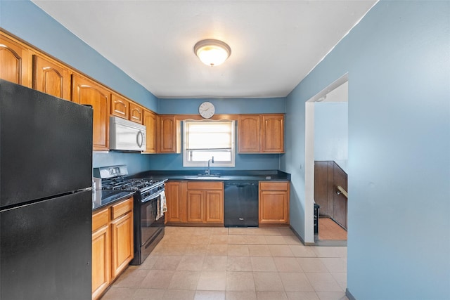 160 Laconia Ave, Staten Island, NY 10305 - kitchen featuring black appliances, a sink, dark countertops, brown cabinetry, and light tile patterned floors
