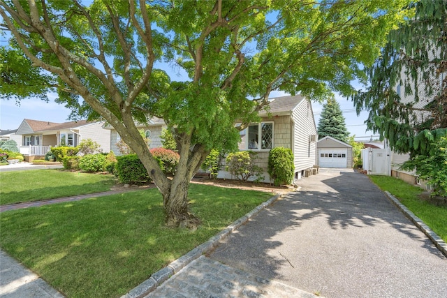 697 Byron Ave, Franklin Square, NY 11010 - view of front of home featuring a garage, an outdoor structure, and a front lawn