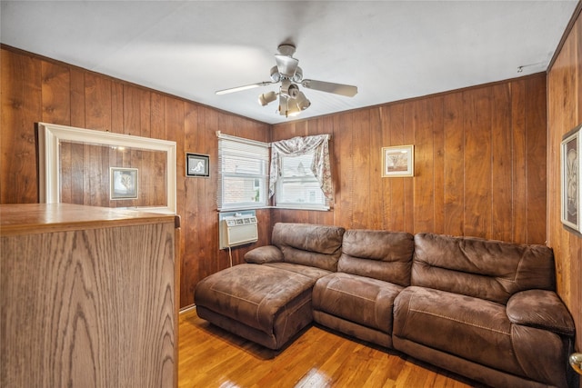 697 Byron Ave, Franklin Square, NY 11010 - living area featuring a ceiling fan, wooden walls, and wood finished floors