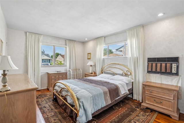 697 Byron Ave, Franklin Square, NY 11010 - bedroom with dark wood-type flooring, a wall mounted AC, and recessed lighting