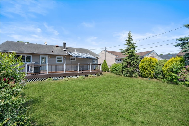 697 Byron Ave, Franklin Square, NY 11010 - rear view of house featuring a wooden deck, a yard, and a shingled roof