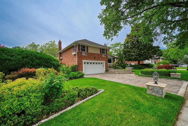 613 Gary Pl, Westbury, NY 11590 - view of front of home with a chimney, a garage, brick siding, and a front lawn
