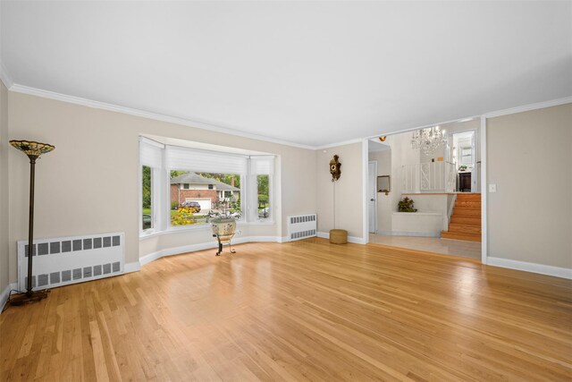 613 Gary Pl, Westbury, NY 11590 - unfurnished living room with radiator heating unit, wood finished floors, ornamental molding, and baseboards