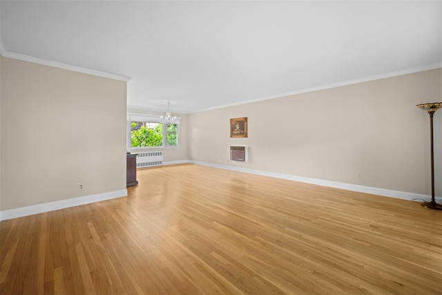613 Gary Pl, Westbury, NY 11590 - unfurnished living room with radiator, a chandelier, light wood finished floors, ornamental molding, and baseboards
