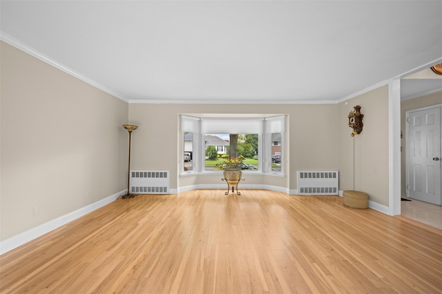 613 Gary Pl, Westbury, NY 11590 - unfurnished living room with radiator heating unit, crown molding, wood finished floors, and baseboards