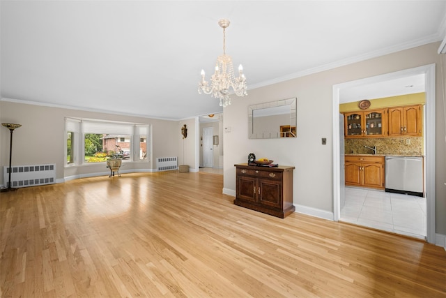 613 Gary Pl, Westbury, NY 11590 - unfurnished living room featuring radiator heating unit, light wood finished floors, a chandelier, and crown molding