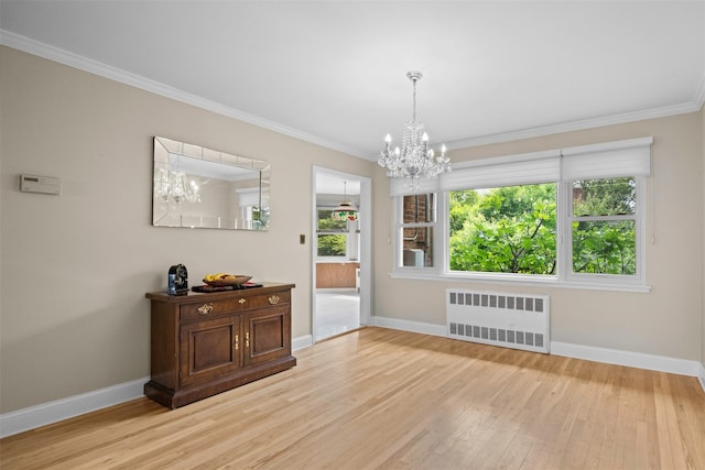613 Gary Pl, Westbury, NY 11590 - empty room featuring radiator heating unit, a chandelier, baseboards, wood finished floors, and crown molding