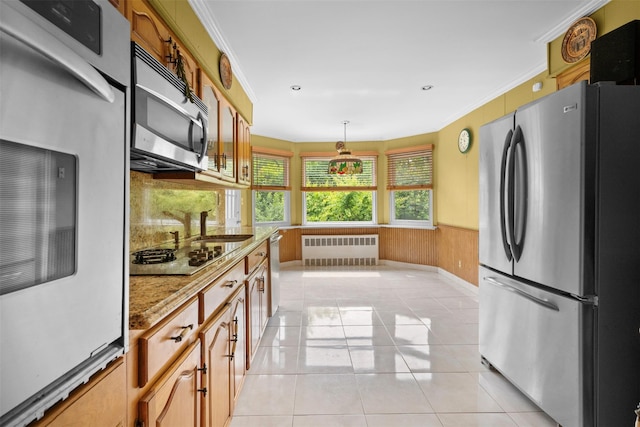 613 Gary Pl, Westbury, NY 11590 - kitchen with appliances with stainless steel finishes, radiator heating unit, ornamental molding, a wainscoted wall, and light tile patterned floors