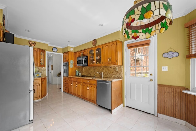 613 Gary Pl, Westbury, NY 11590 - kitchen featuring appliances with stainless steel finishes, brown cabinetry, backsplash, glass insert cabinets, and ornamental molding
