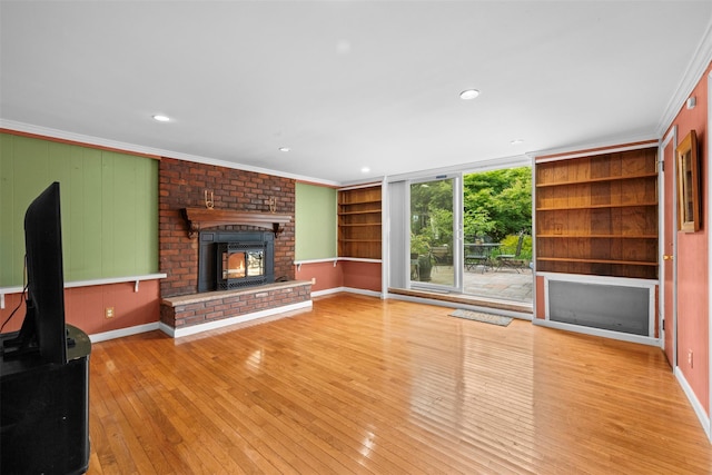 613 Gary Pl, Westbury, NY 11590 - unfurnished living room featuring a fireplace, wood-type flooring, ornamental molding, built in features, and baseboards