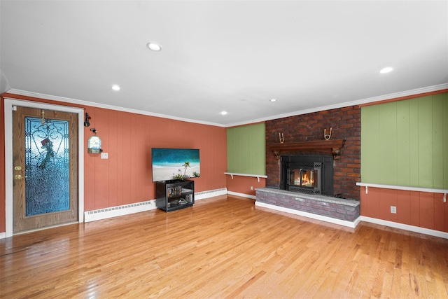 613 Gary Pl, Westbury, NY 11590 - unfurnished living room featuring wood finished floors, crown molding, baseboards, a fireplace, and a baseboard radiator