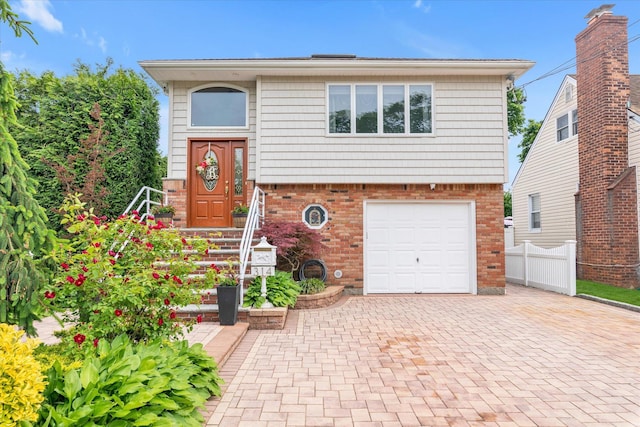 314 Oakview Ave, Oceanside, NY 11572 - split foyer home with brick siding, decorative driveway, and an attached garage