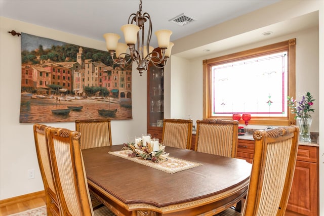 314 Oakview Ave, Oceanside, NY 11572 - dining area with a chandelier, wood finished floors, and baseboards