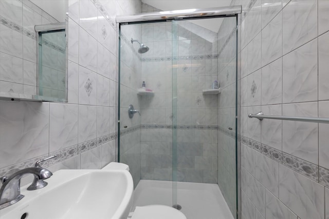314 Oakview Ave, Oceanside, NY 11572 - bathroom with tile walls, a sink, a shower stall, and toilet