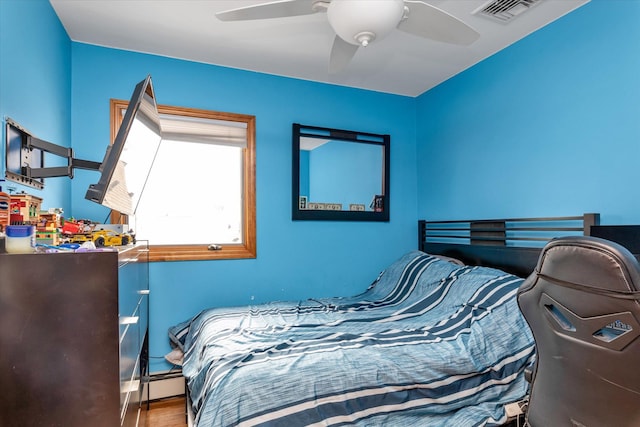 314 Oakview Ave, Oceanside, NY 11572 - bedroom featuring wood finished floors, ceiling fan, and a baseboard radiator