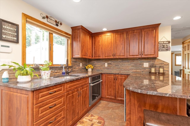 314 Oakview Ave, Oceanside, NY 11572 - kitchen featuring oven, a sink, a peninsula, tasteful backsplash, and recessed lighting