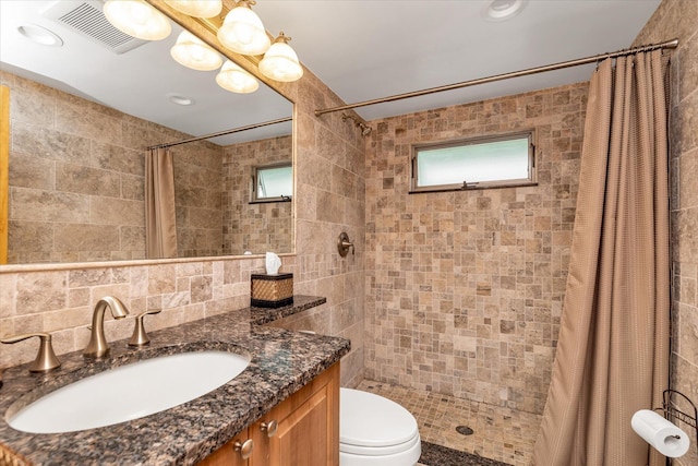 314 Oakview Ave, Oceanside, NY 11572 - bathroom with tile walls, tiled shower, vanity, toilet, and decorative backsplash