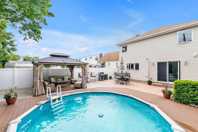 314 Oakview Ave, Oceanside, NY 11572 - view of swimming pool featuring an outdoor living space, a gazebo, a wooden deck, a fenced backyard, and a grill