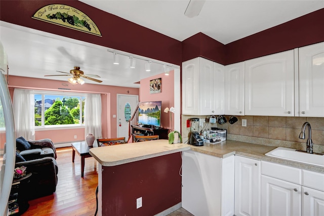 674 Shore Rd, Lindenhurst, NY 11757 - kitchen featuring a sink, ceiling fan, light countertops, and light wood-style floors