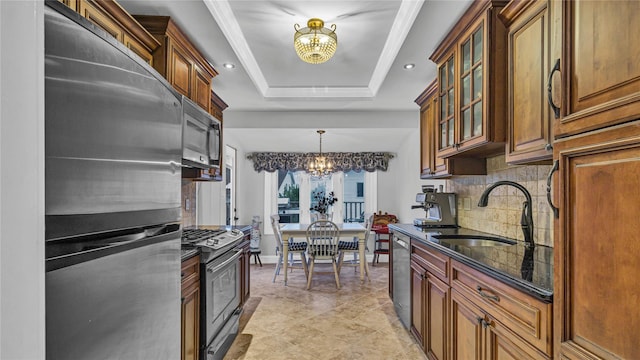 3123 Lydia Ln, Bellmore, NY 11710 - kitchen featuring stainless steel appliances, a chandelier, a tray ceiling, backsplash, and dark stone counters