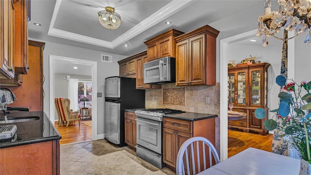 3123 Lydia Ln, Bellmore, NY 11710 - kitchen with a chandelier, appliances with stainless steel finishes, tasteful backsplash, ornamental molding, and light tile patterned flooring