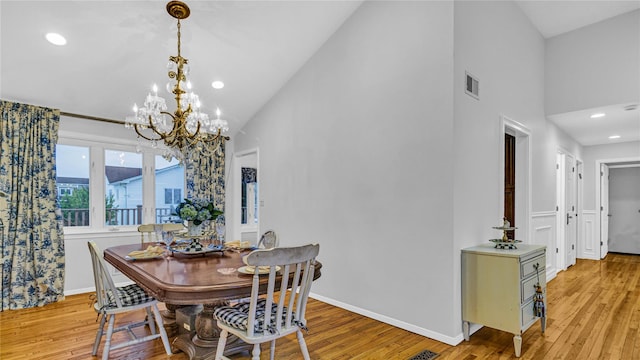 3123 Lydia Ln, Bellmore, NY 11710 - dining area with light wood-style floors, a chandelier, high vaulted ceiling, and recessed lighting
