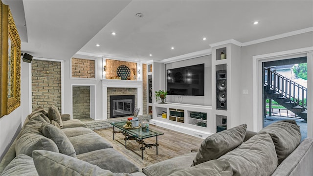 3123 Lydia Ln, Bellmore, NY 11710 - living room featuring crown molding, recessed lighting, stairway, wood finished floors, and a fireplace