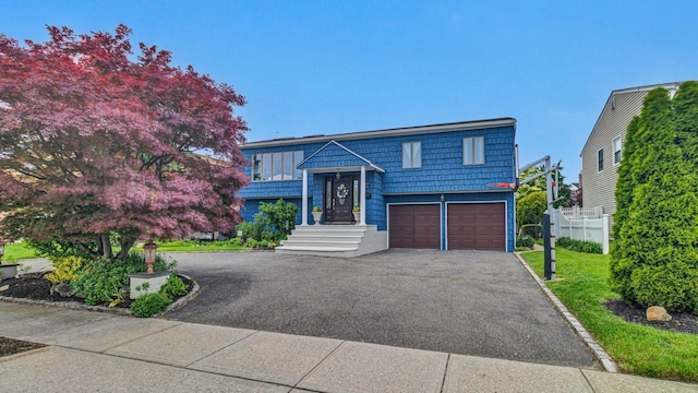 3123 Lydia Ln, Bellmore, NY 11710 - bi-level home with asphalt driveway and an attached garage