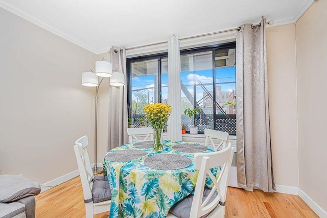 2121 Shore Pkwy Unit 2P, Brooklyn, NY 11214 - dining room featuring crown molding, light wood finished floors, baseboards, and healthy amount of natural light