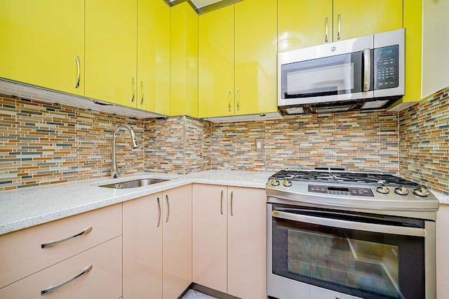 2121 Shore Pkwy Unit 2P, Brooklyn, NY 11214 - kitchen featuring appliances with stainless steel finishes, a sink, backsplash, and light stone counters