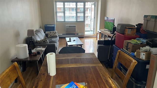 52-40 39th Dr Unit 9J, Woodside, NY 11377 - living area featuring wood-type flooring, a wall mounted air conditioner, and a baseboard radiator