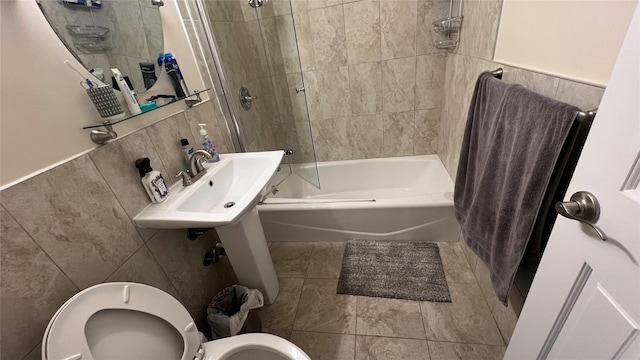 52-40 39th Dr Unit 9J, Woodside, NY 11377 - bathroom featuring tile walls, toilet, bathing tub / shower combination, and a sink