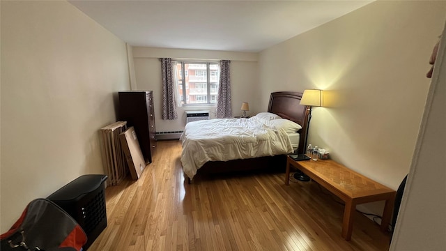 52-40 39th Dr Unit 9J, Woodside, NY 11377 - bedroom with baseboard heating, light wood-type flooring, and radiator