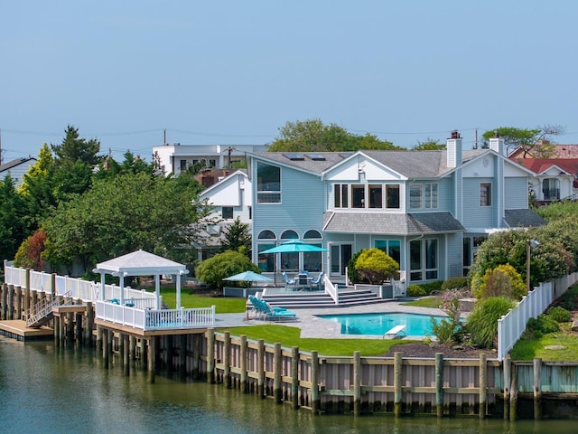 1416 Bay Blvd, Atlantic Beach, NY 11509 - rear view of house with a gazebo, an outdoor pool, and a water view