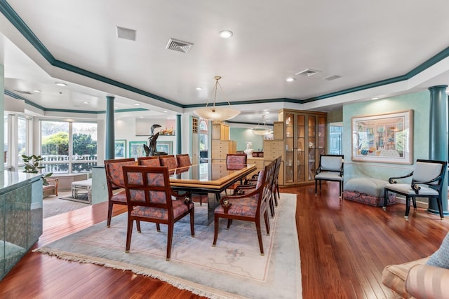 1416 Bay Blvd, Atlantic Beach, NY 11509 - dining space with ornamental molding, ornate columns, wood finished floors, a tray ceiling, and recessed lighting