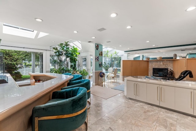 1416 Bay Blvd, Atlantic Beach, NY 11509 - kitchen featuring a skylight, open floor plan, a fireplace, and recessed lighting