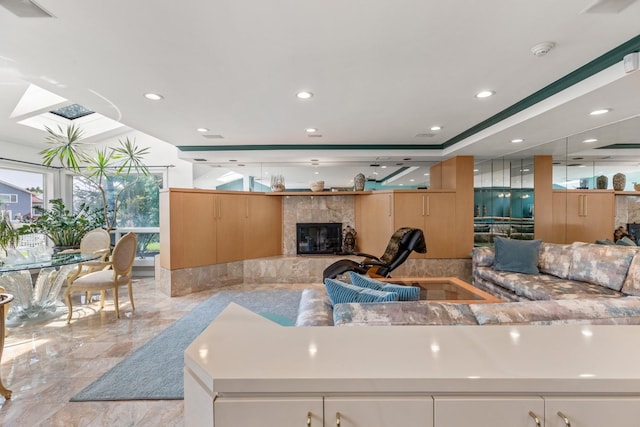 1416 Bay Blvd, Atlantic Beach, NY 11509 - living room featuring light marble finish flooring, a fireplace, a skylight, and recessed lighting