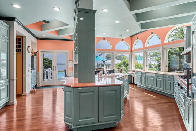1416 Bay Blvd, Atlantic Beach, NY 11509 - kitchen with dark wood finished floors, plenty of natural light, light countertops, green cabinets, and ornamental molding