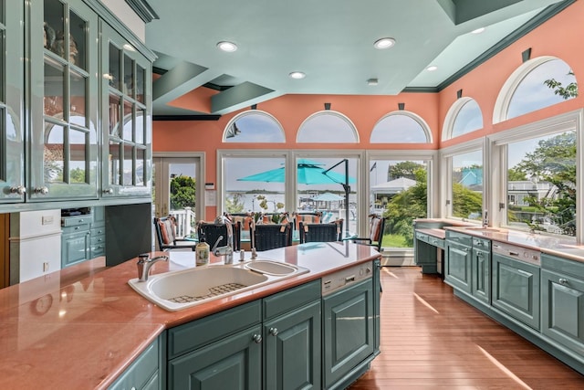 1416 Bay Blvd, Atlantic Beach, NY 11509 - kitchen with green cabinetry, hardwood / wood-style floors, light countertops, glass insert cabinets, and recessed lighting