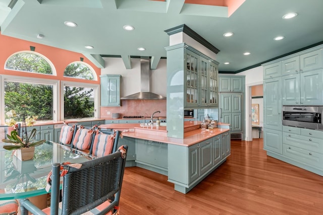 1416 Bay Blvd, Atlantic Beach, NY 11509 - kitchen featuring wall chimney exhaust hood, light wood-type flooring, light countertops, decorative backsplash, and gray cabinets
